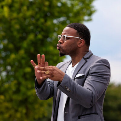 An American Sign Language interpreter interpreting at an anti-racism rally and march.