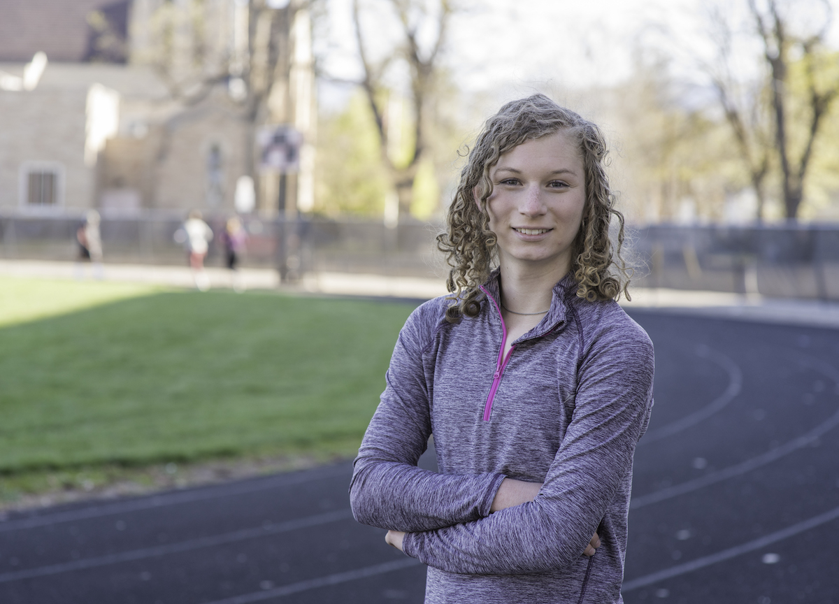 Photo of Lindsay Hexoc, a white woman with blonde hair in exercise clothing standing on a track