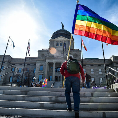 Demonstrators gather on the steps of the Montana State Capitol protesting anti-LGBTQ+ legislation.