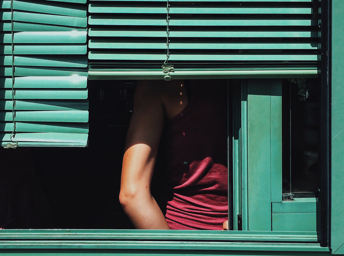 Woman Behind Shutters