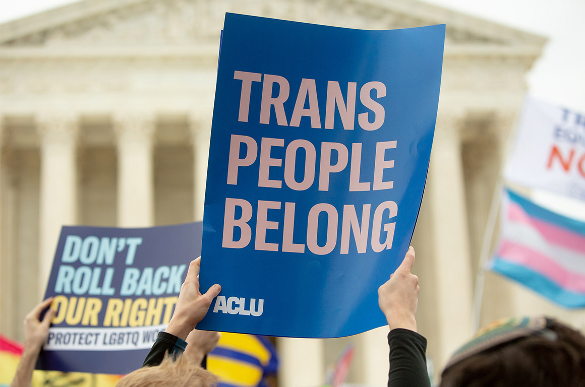 Demonstrators outside the Supreme Court carrying signs advocating for LGBTQ rights