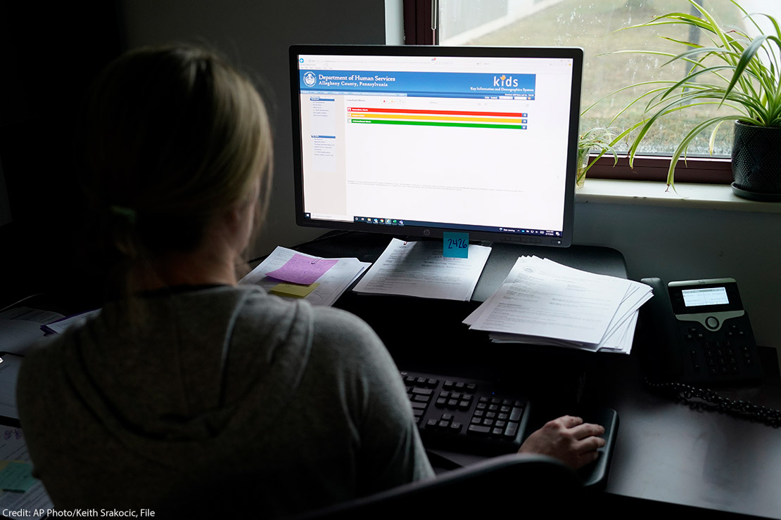 A case work supervisor looks over the first screen of software used by workers who field calls at an intake call screening center for the Allegheny County Children.