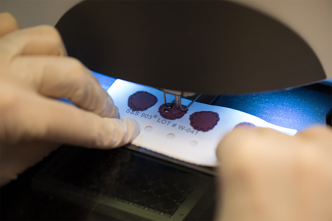 A file card marked with the blood of a newborn is screened to test for genetic illnesses.