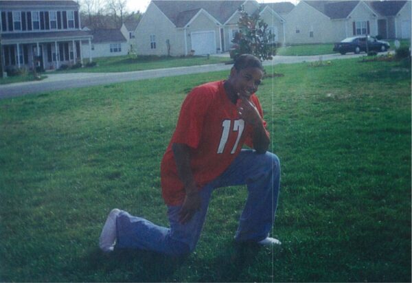 Hasson Bacote posing in a football jersey.