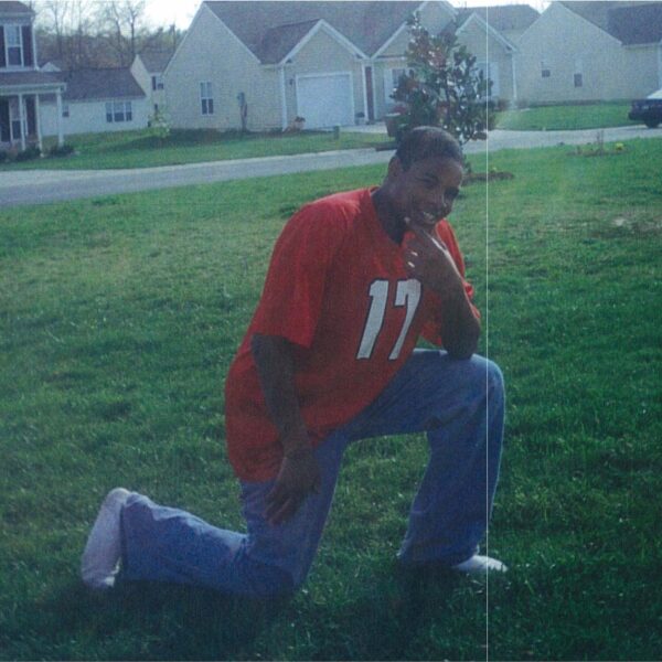 Hasson Bacote posing in a football jersey.