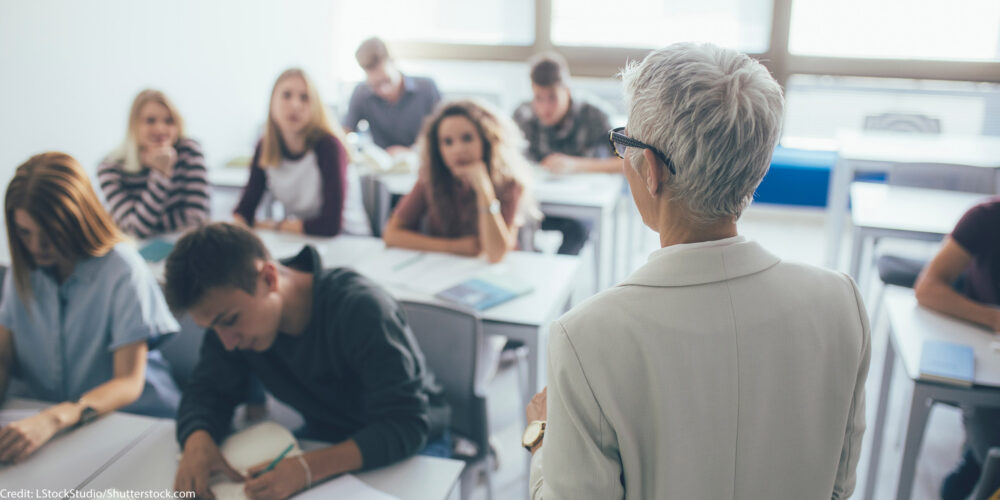 A collage professor in front of a class.