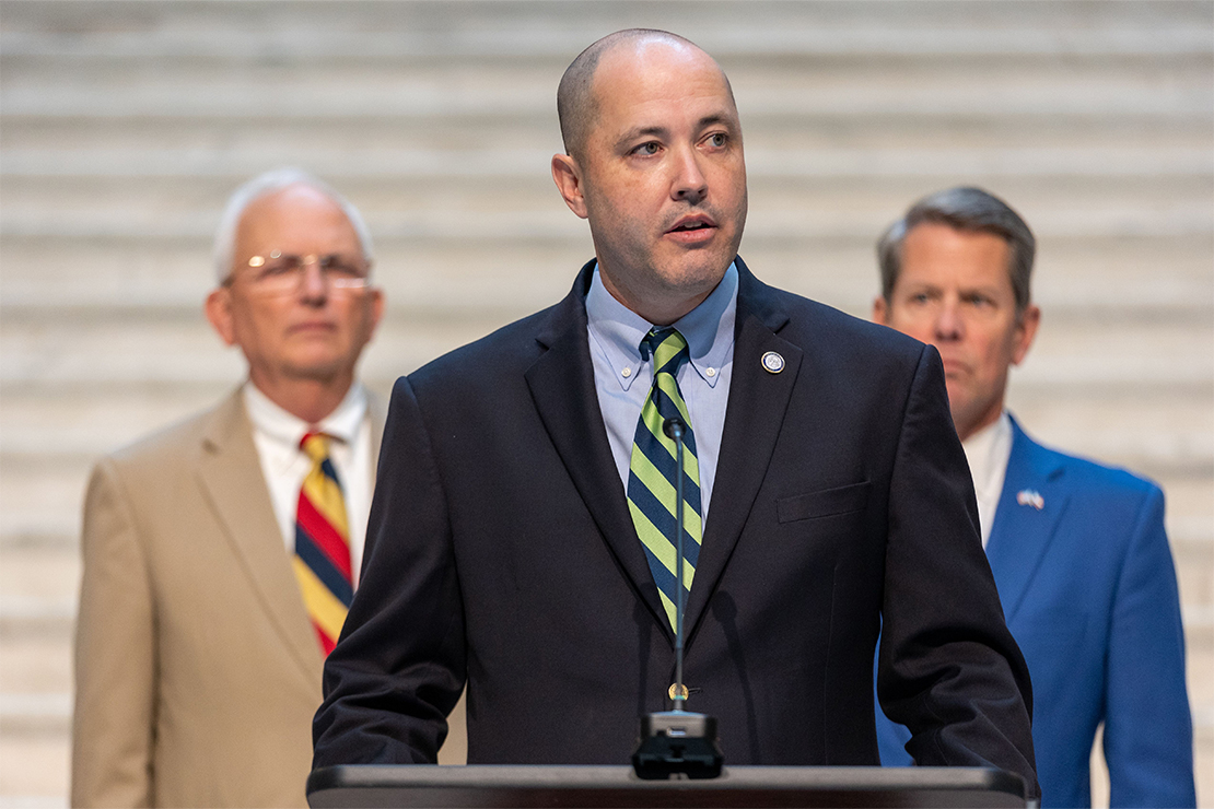 Georgia attorney general Chris Carr speaks at a press conference in Atlanta, as Georgia governor BrianKemp (in the background to the right) looks on.