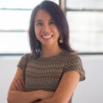 Headshot of attorney Bethany Li smiling with her arms folded across her chest