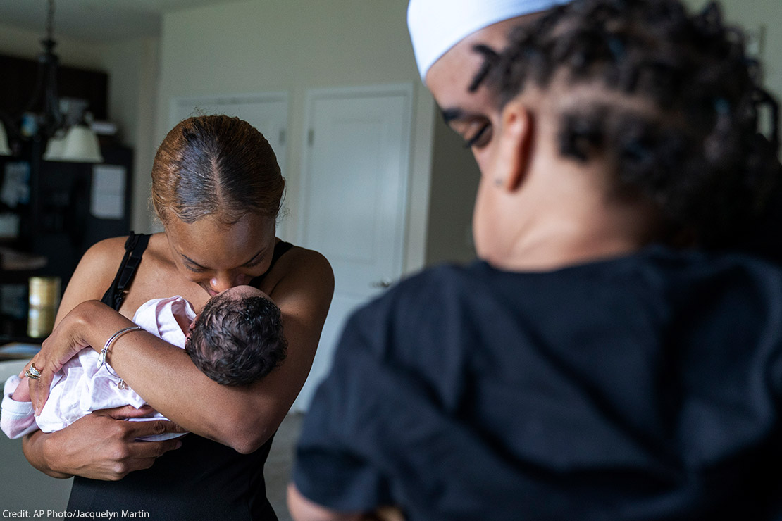 A couple holding their two children.