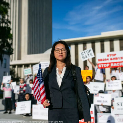 Echo King, an attorney from Orlando, Florida, stands in front of protesters who rallied in opposition to SB264 and HB1355 in front of the Capitol on Wednesday, April 19, 2023.