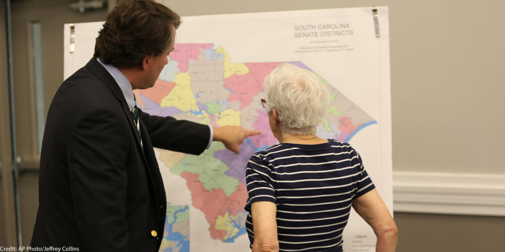 People look over the current South Carolina Senate districts at a public meeting by a Senate subcommittee on redistricting.