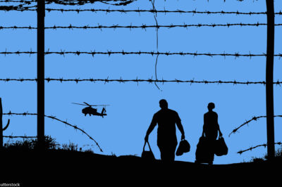 A man and woman with baggage at the border.